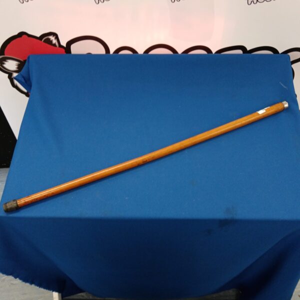 Vintage malaka wood cane on blue background.