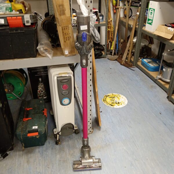 Used Dyson V8 cordless vacuum cleaner in a home setting.