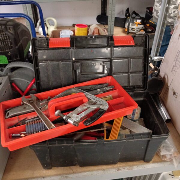 Vintage metal tool box filled with various hand tools and chisels.