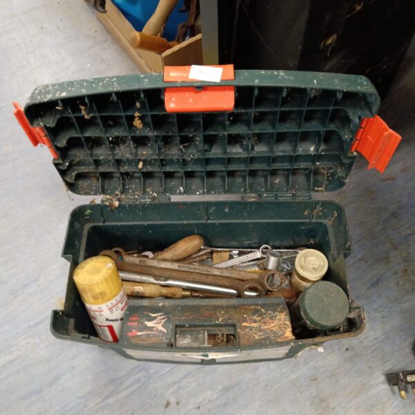 Vintage metal toolbox filled with spanners and hand tools.
