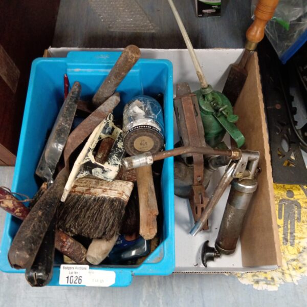 Vintage tool lot with oil cans and grease gun for workshop use.