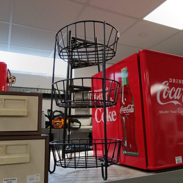 Black wire vegetable rack for kitchen storage and display.