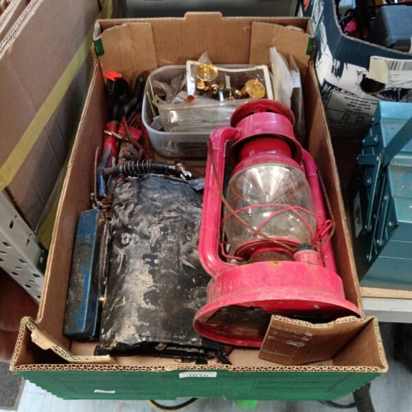 Mixed tool lot featuring a red vintage lantern and various hand tools.