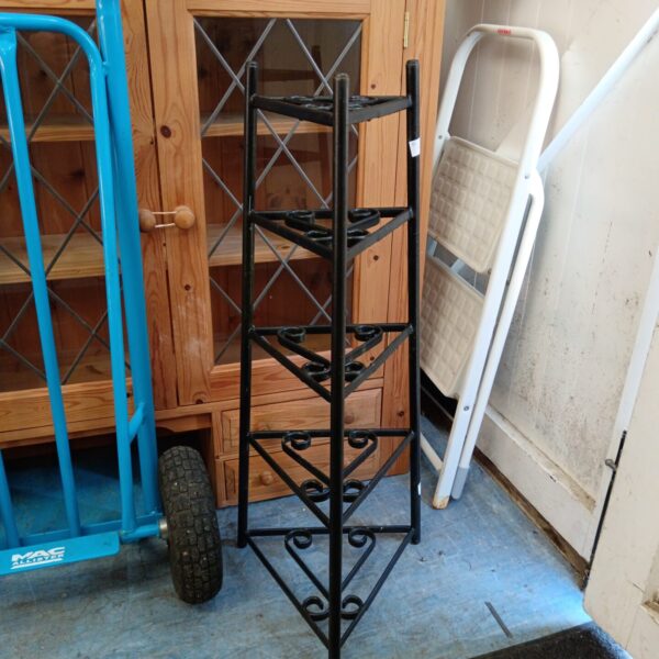 Vintage wrought iron pot stand with tiered display.
