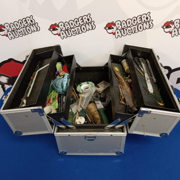 Vintage aluminium crafting box filled with colourful crafting supplies.