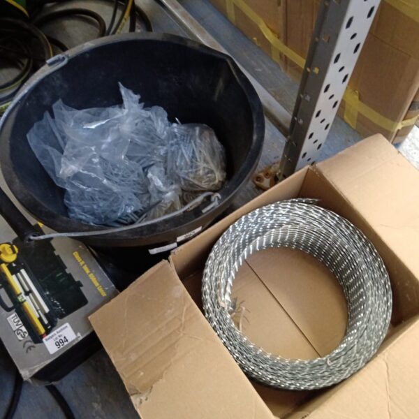 Galvanised nails in a bucket with a roll of metal mesh.