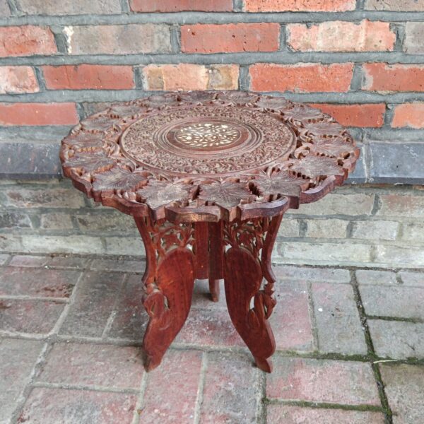 Intricate carving on antique Anglo Indian teak table.
