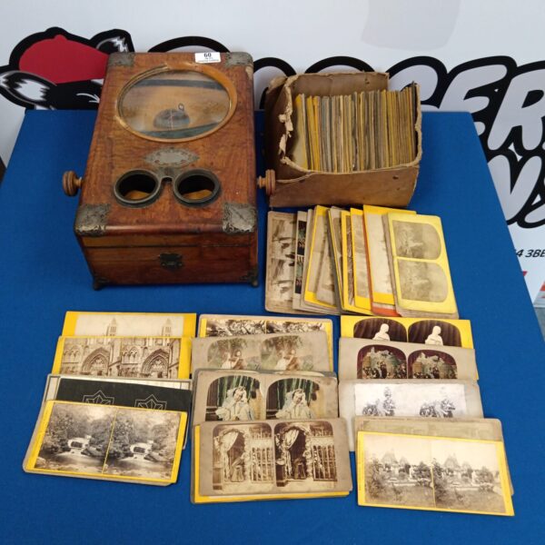 Antique Victorian stereoscopic viewer with collection of stereoscopic photo cards.