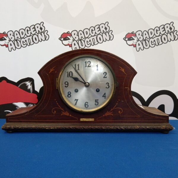 Vintage Napoleon mantle clock with a wooden case.