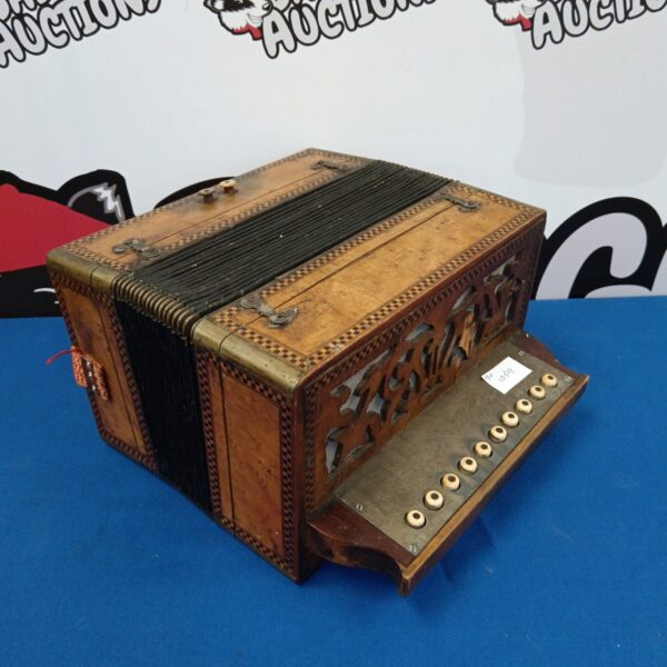Antique walnut accordion with intricate parquetry inlay detail.