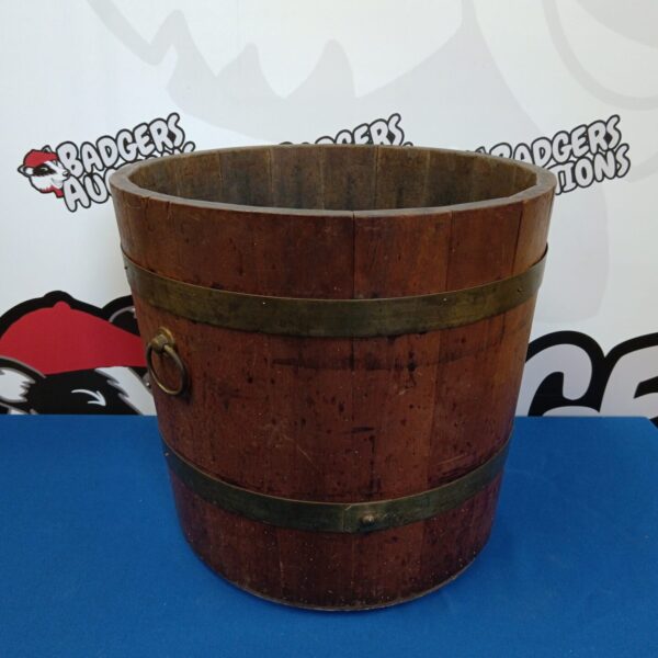 Vintage wooden barrel with metal bands, rustic farmhouse style.