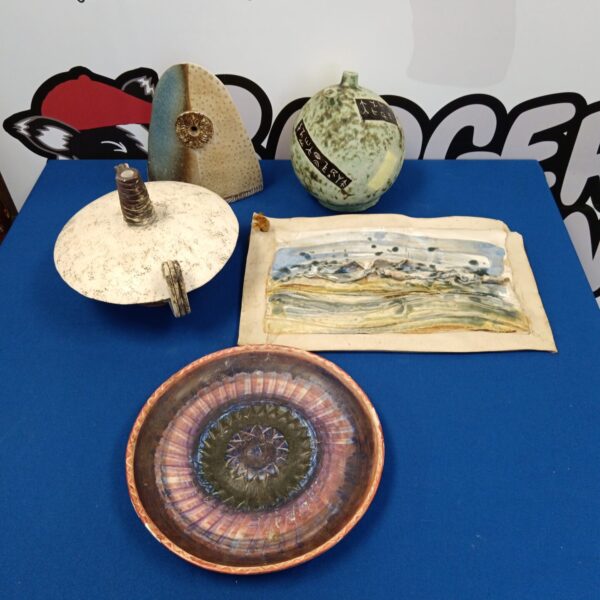 Vintage studio pottery collection featuring a vase and wall plaque.