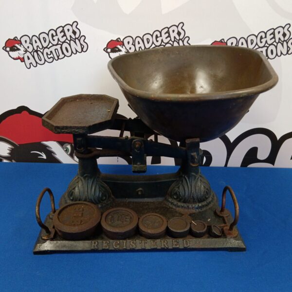 Antique cast iron registered scales with scale pans.