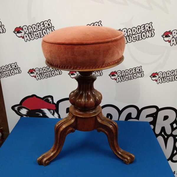 Antique Victorian piano stool with upholstered seat.