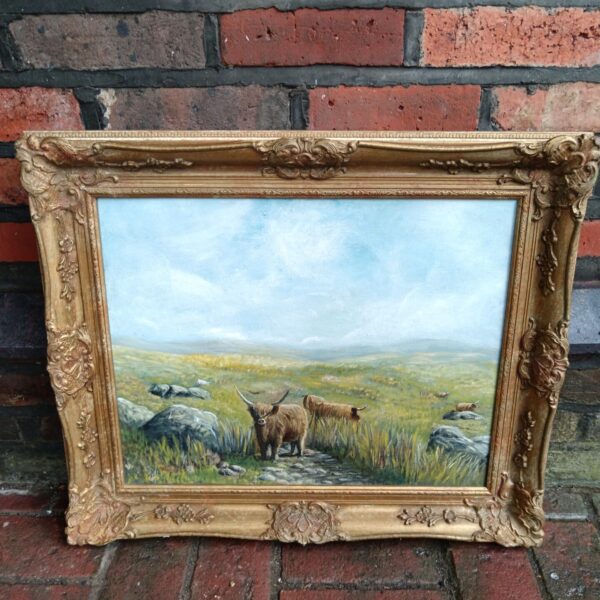 Vintage oil painting of Highland cattle in a Scottish landscape with a gilt frame.