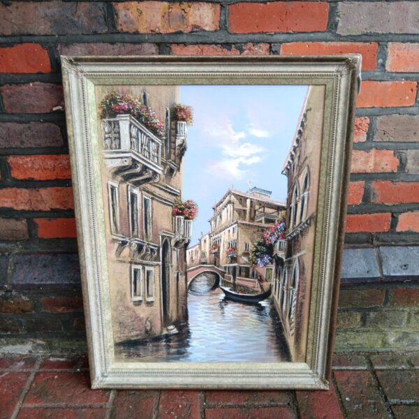 Signed oil painting of a Venice canal scene with gondolas.