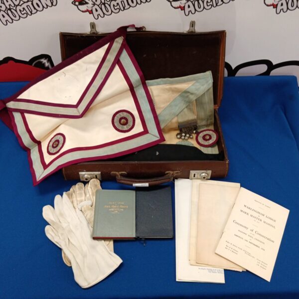 Antique vintage Masonic case with aprons and gloves displayed.