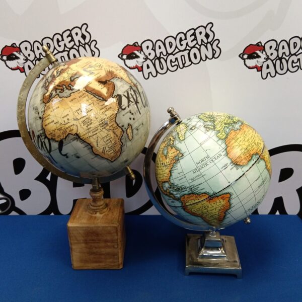 Vintage desktop globe on wooden base, detailed geographical markings.