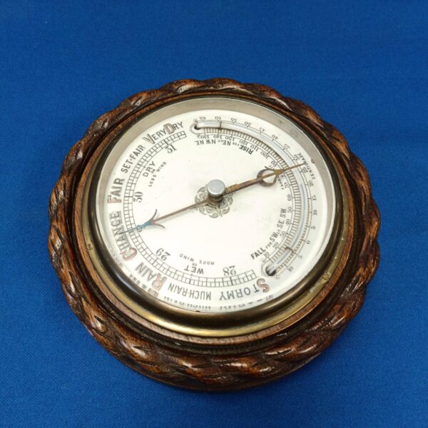 Close-up of antique mercury barometer with visible scale and glass tube.