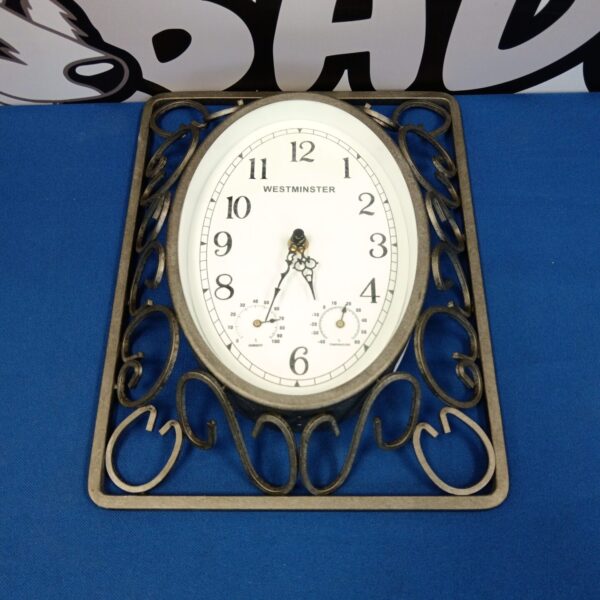 Vintage wrought iron Westminster wall clock with Roman numerals.