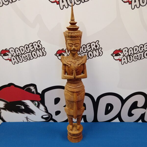 Intricately carved Indonesian wooden Buddha statue for collectors.