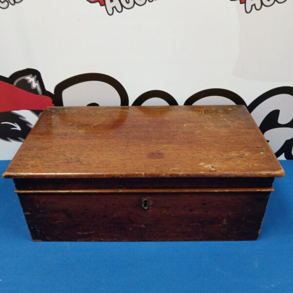 Vintage wooden box with three compartments, front view.