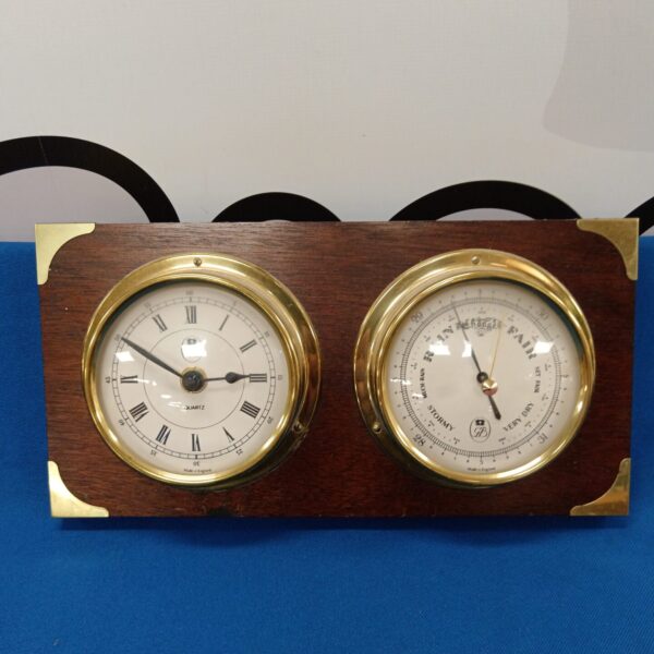 Vintage GB quartz clock and barometer on a wall.