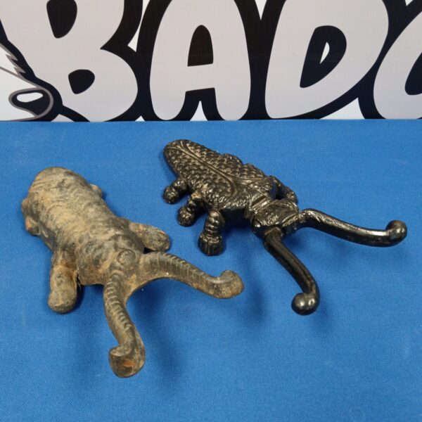 Vintage cast iron boot scrapers with ornate detailing.