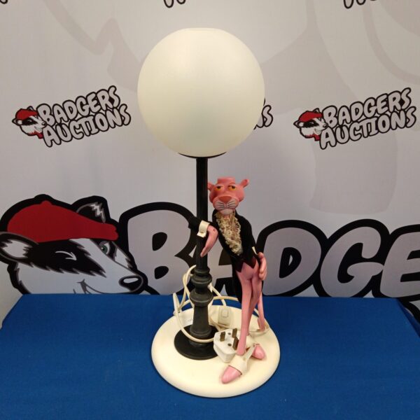 Vintage pink panther table lamp with frosted glass shade.
