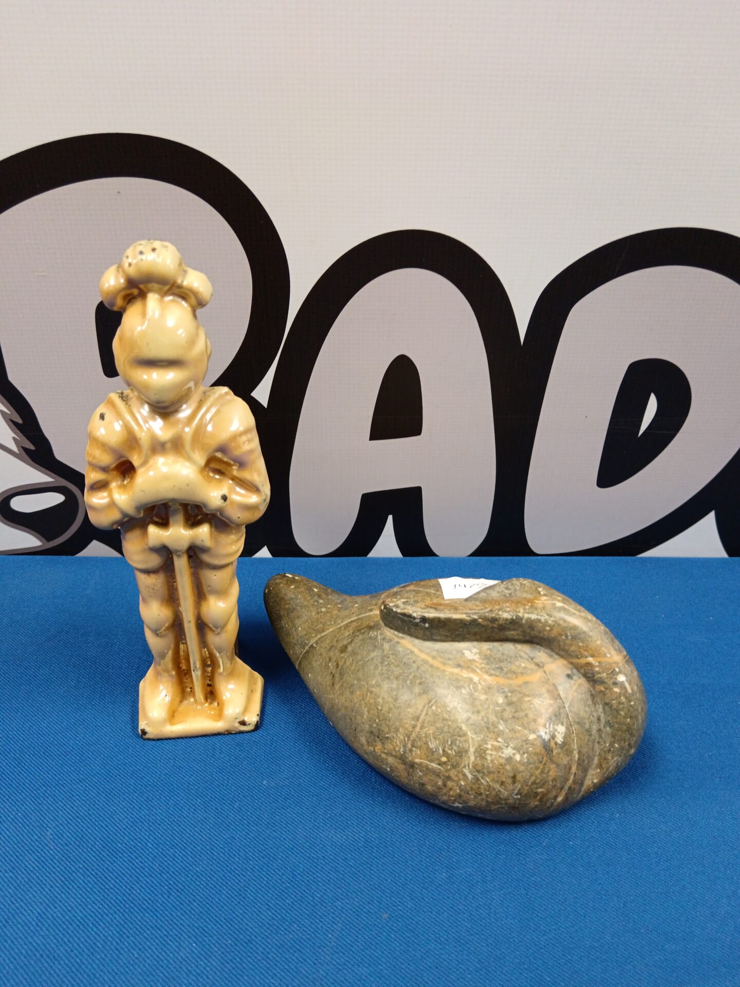 051 Cast iron lustreware knight doorstop & carved stone goose