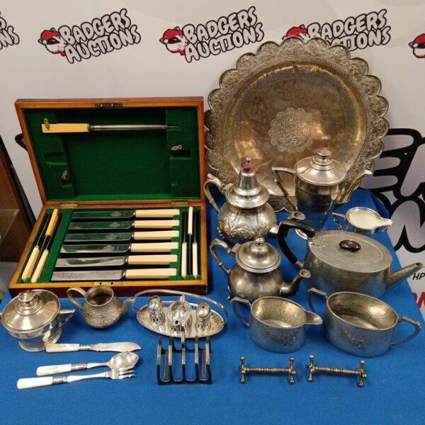 Vintage silver plate lot with cutlery, teapot, and sugar bowl.