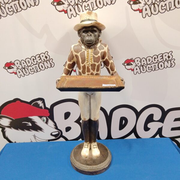 Vintage wooden monkey butler figurine holding a tray.