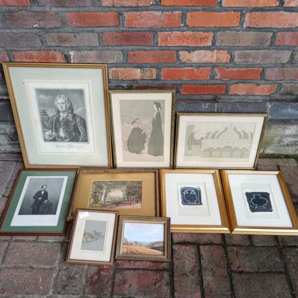 Collection of framed antique prints and vintage artwork for wall decor.