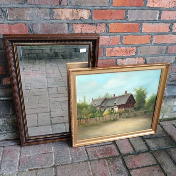 Vintage oil painting and mirror set with gilt frames and cottage scene.