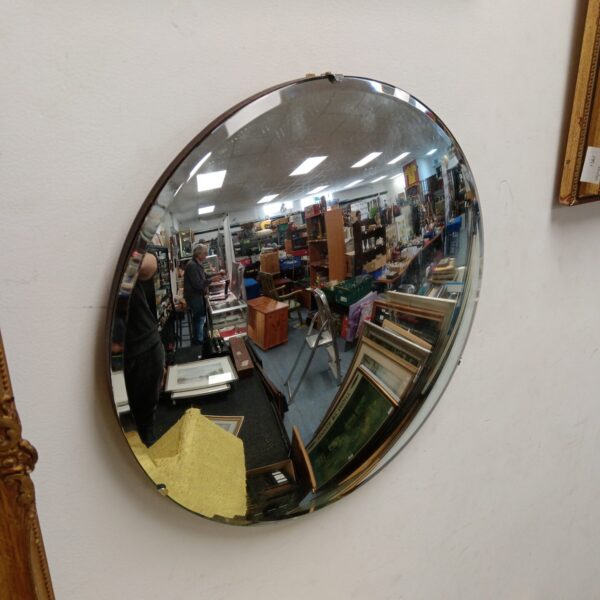Vintage convex round mirror with bevelled edge for wall decoration.