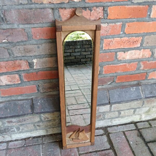 Vintage rustic hall mirror with carved ship design.