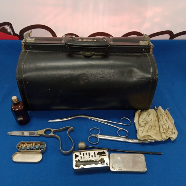 Vintage doctor's medical case with surgical instruments inside.