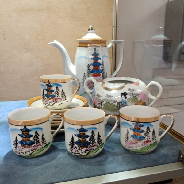 Vintage Japanese teaset with delicate floral pattern and bone china finish.