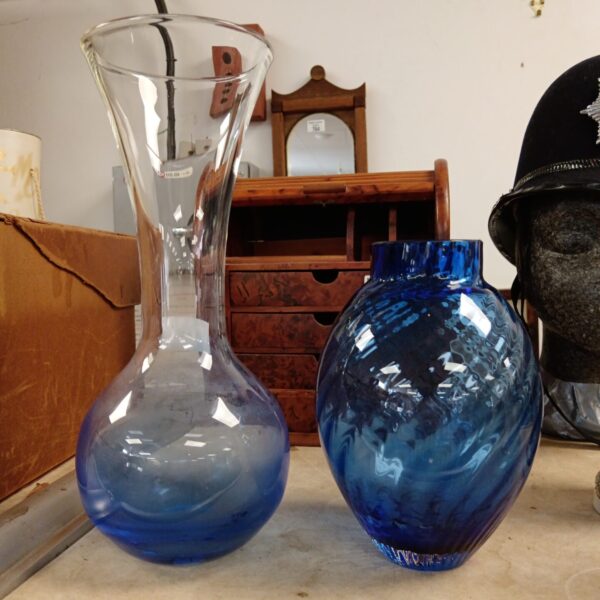 Two blue art glass vases with unique shapes.