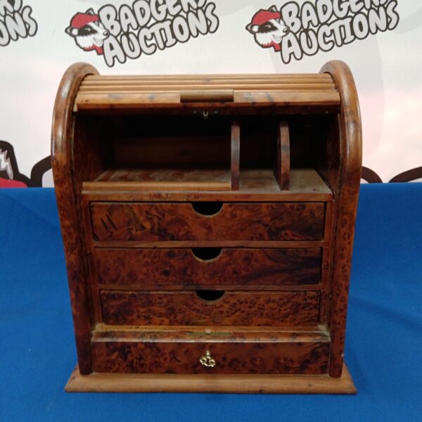 Vintage walnut roll top stationery box on a dark surface.