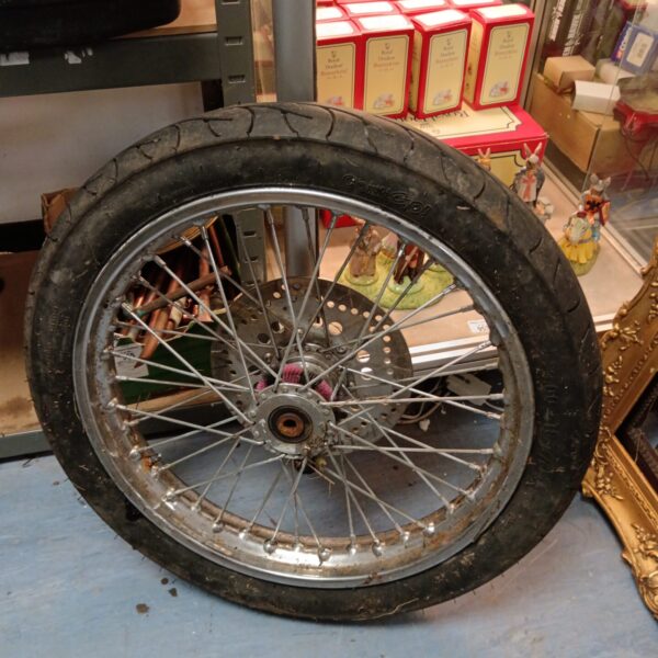 Used Kawasaki Z750 motorcycle wheel with spoked rim.