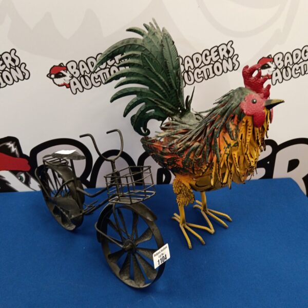 Detailed metal chicken and bicycle garden ornament with a rustic finish.