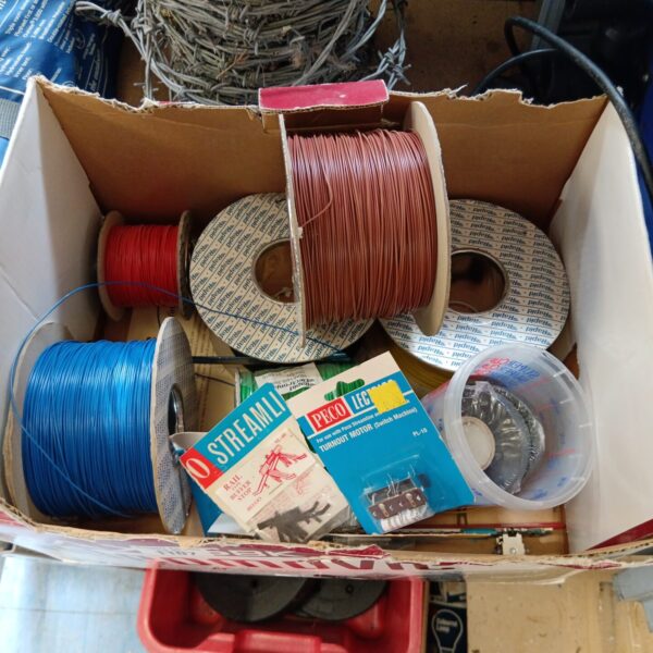 Vintage model train wire and accessories lot for collectors.