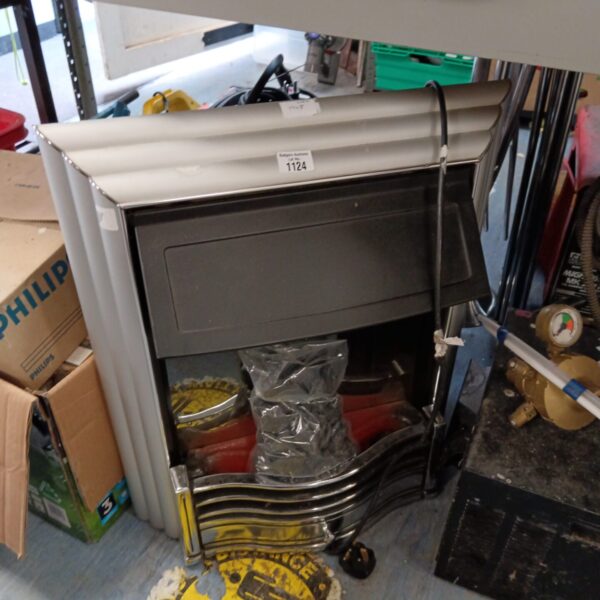 White vintage electric fireplace with coal effect, retro heater.