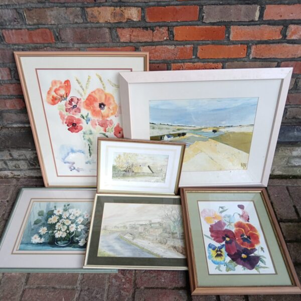 Vintage framed floral artwork in a collection of prints.