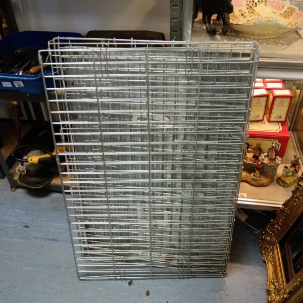 Large folding metal dog cage for pet containment.