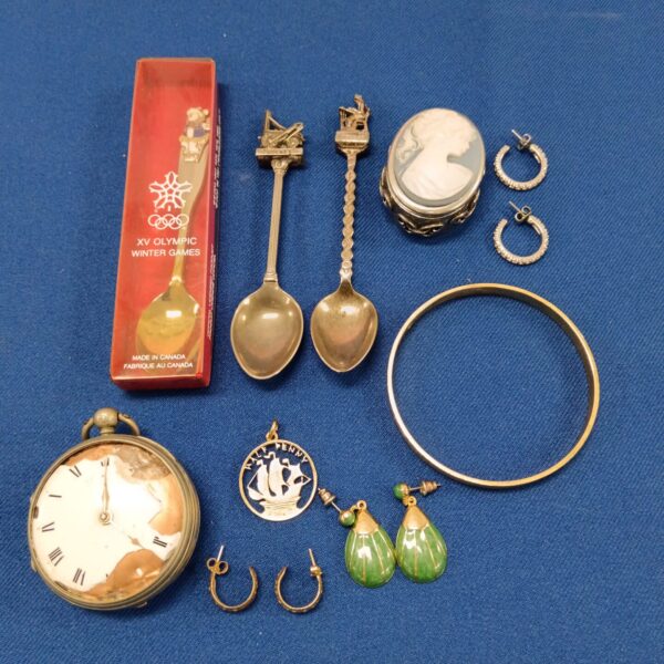 Vintage mixed curios lot featuring a pocket watch and collector's spoons.