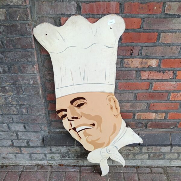 Large vintage wooden chef head, a unique restaurant sign.