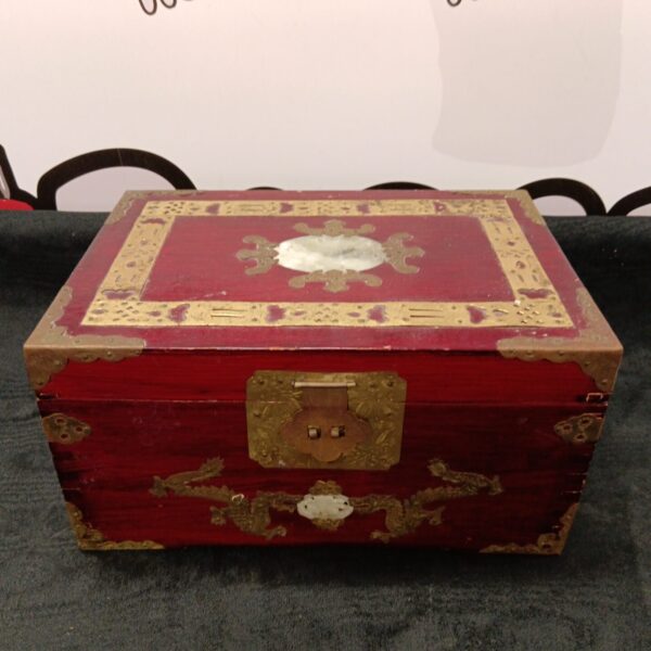 Vintage Oriental jewellery box with red lacquer and brass details.