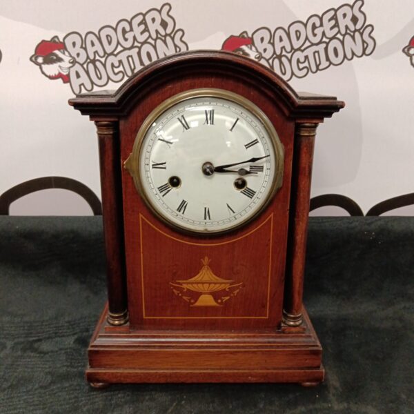Antique Edwardian mahogany mantle clock with inlaid detail.